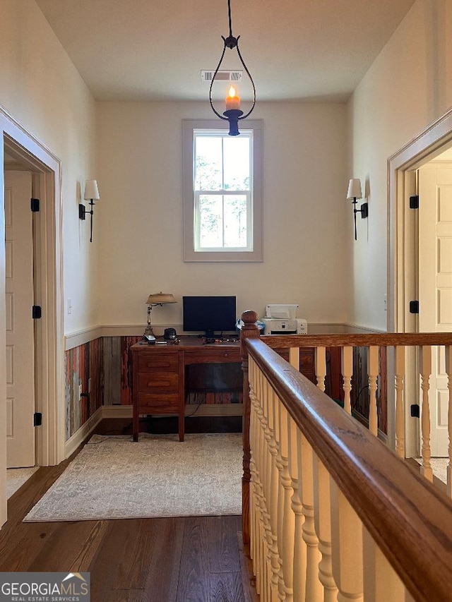 office area featuring dark wood-type flooring and wood walls