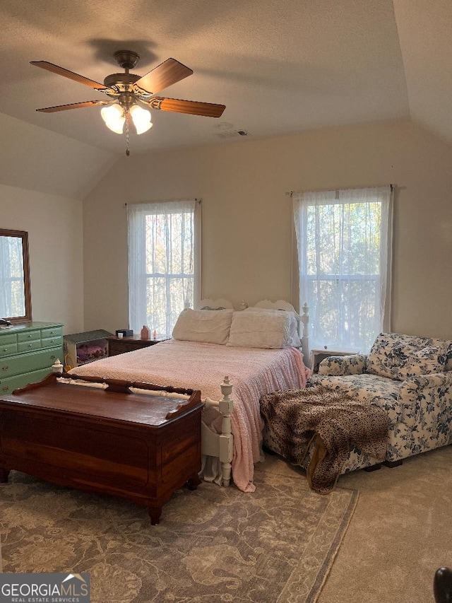 carpeted bedroom featuring vaulted ceiling and ceiling fan