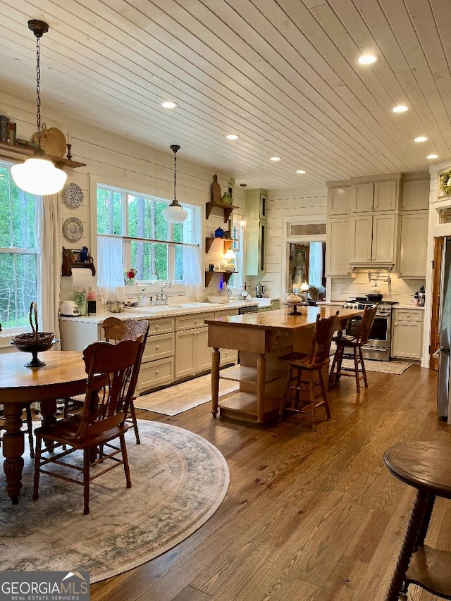 182 Rogers St, Hazlehurst, GA 31539 - kitchen with appliances with stainless steel finishes, open shelves, dark wood finished floors, a kitchen island, and light countertops