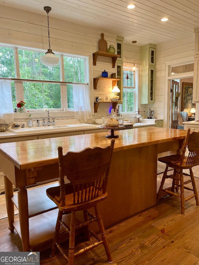 182 Rogers St, Hazlehurst, GA 31539 - kitchen with butcher block countertops, dark wood-style flooring, recessed lighting, a kitchen breakfast bar, and pendant lighting