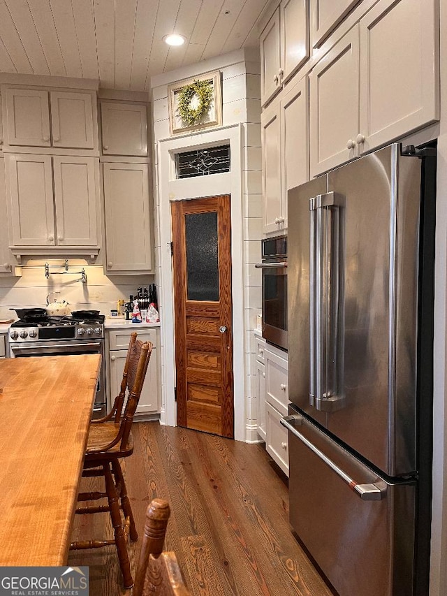 182 Rogers St, Hazlehurst, GA 31539 - kitchen with appliances with stainless steel finishes, butcher block counters, dark wood-type flooring, recessed lighting, and wooden ceiling