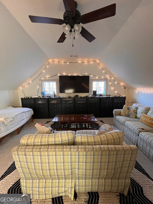 living room featuring lofted ceiling and carpet floors