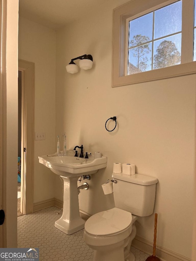 bathroom with tile patterned flooring and toilet