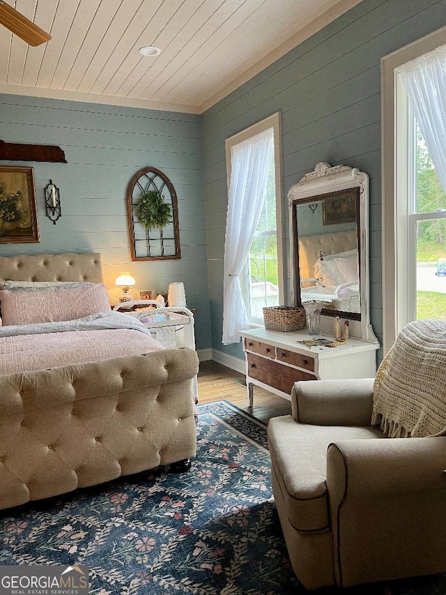 182 Rogers St, Hazlehurst, GA 31539 - bedroom with wooden walls, light wood-type flooring, and wooden ceiling