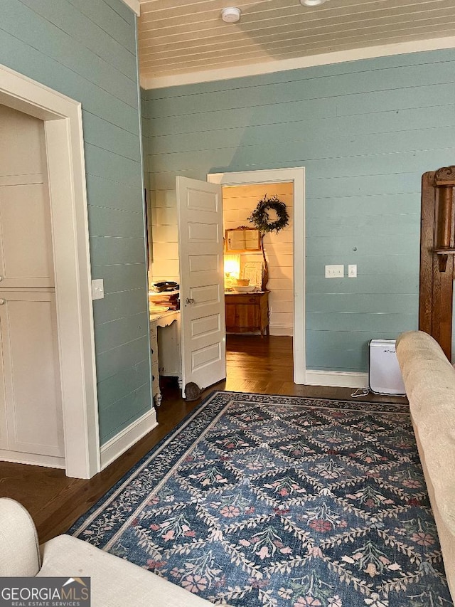 182 Rogers St, Hazlehurst, GA 31539 - corridor with dark wood finished floors, wooden walls, and baseboards