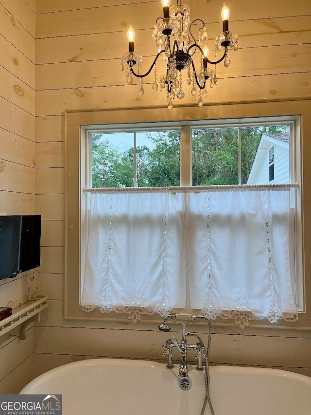 182 Rogers St, Hazlehurst, GA 31539 - full bath with a soaking tub, a chandelier, and wood walls
