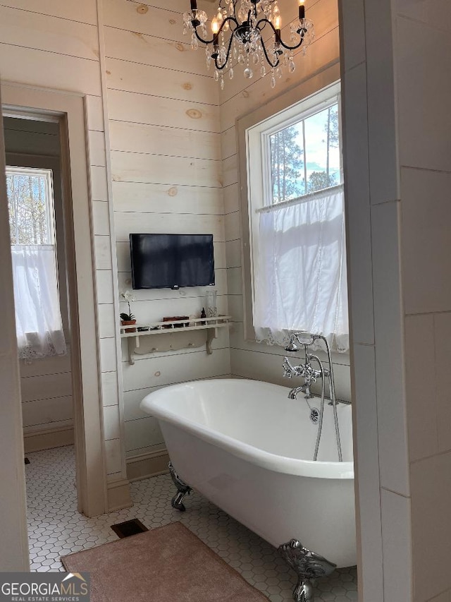 182 Rogers St, Hazlehurst, GA 31539 - full bathroom with healthy amount of natural light, a chandelier, and a freestanding bath