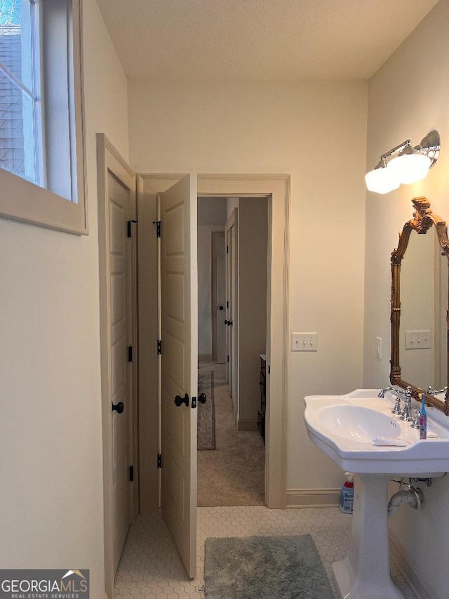 182 Rogers St, Hazlehurst, GA 31539 - bathroom with baseboards and tile patterned floors