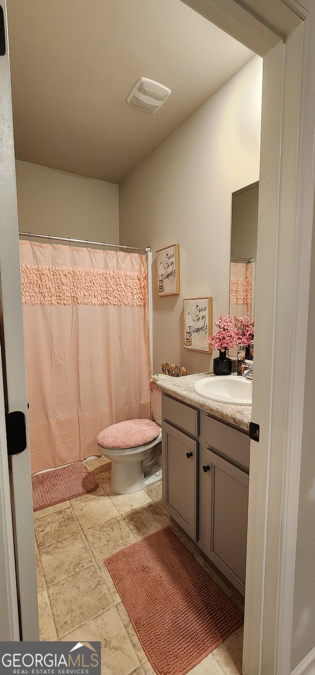 bathroom featuring vanity and toilet