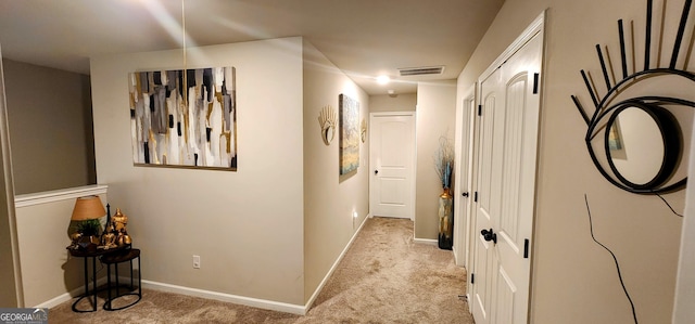 hallway with light colored carpet