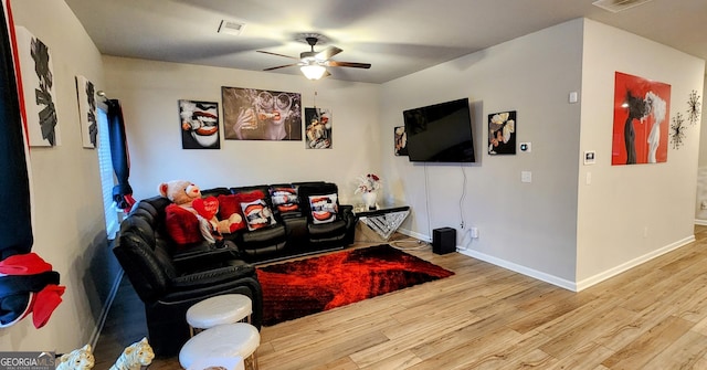 living room featuring ceiling fan and light hardwood / wood-style flooring