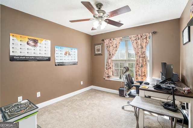 office space with ceiling fan, light carpet, and a textured ceiling