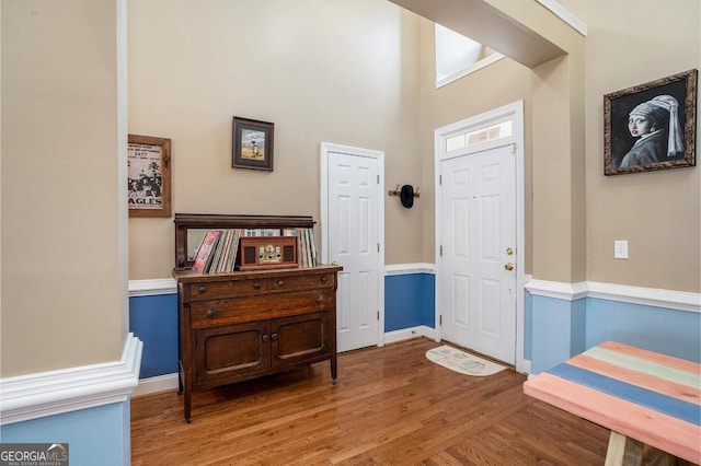 entryway featuring a high ceiling and light wood-type flooring