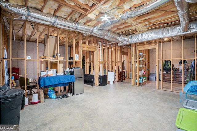 basement featuring stainless steel refrigerator