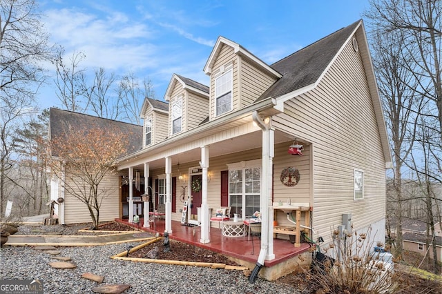 new england style home featuring a porch