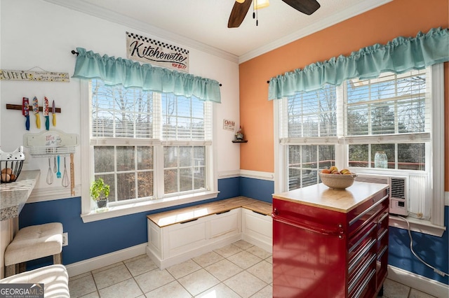 interior space featuring ornamental molding, a wealth of natural light, ceiling fan, and light tile patterned floors