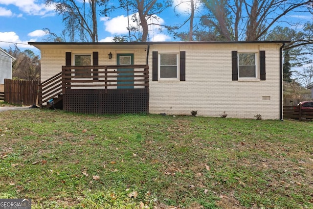 view of front of house featuring a front yard and a deck