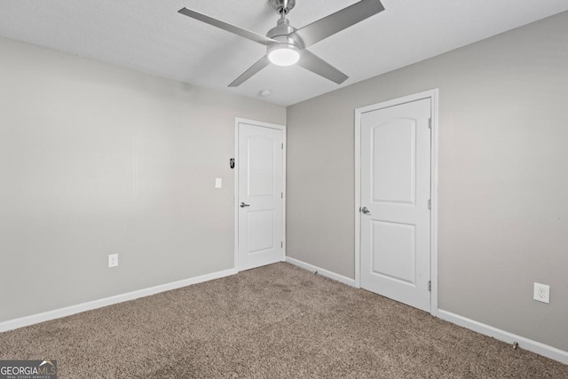 spare room featuring carpet floors and ceiling fan