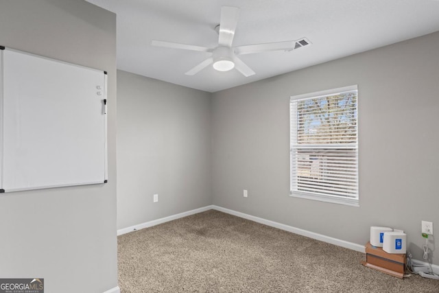 carpeted spare room with ceiling fan