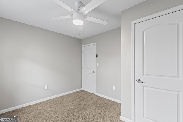 unfurnished bedroom with ceiling fan and light colored carpet