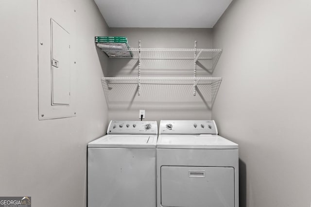 clothes washing area featuring separate washer and dryer and electric panel