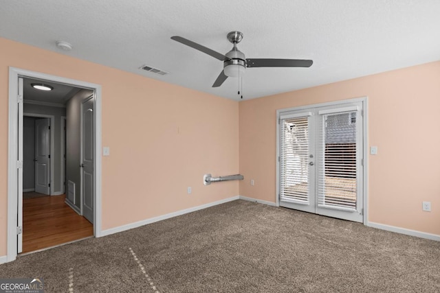 unfurnished room featuring carpet flooring, a textured ceiling, and ceiling fan