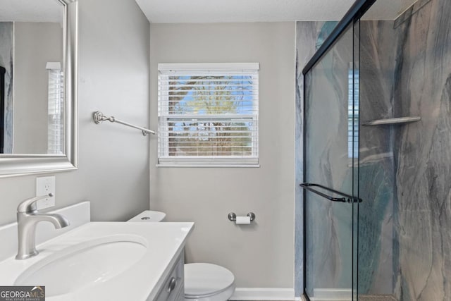 bathroom featuring vanity, toilet, and walk in shower