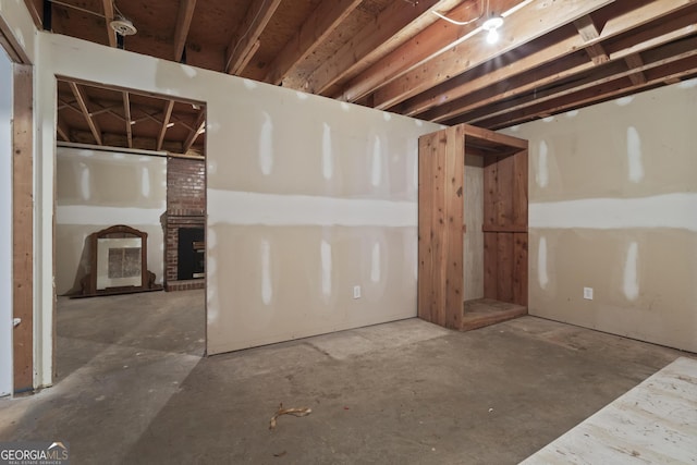 unfinished basement with a fireplace