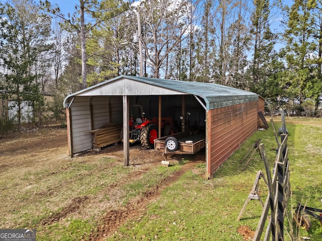 view of pole building with a lawn and driveway