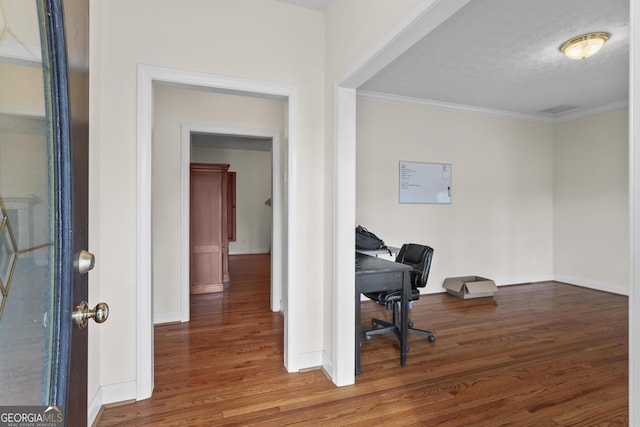 home office with wood finished floors, baseboards, and ornamental molding