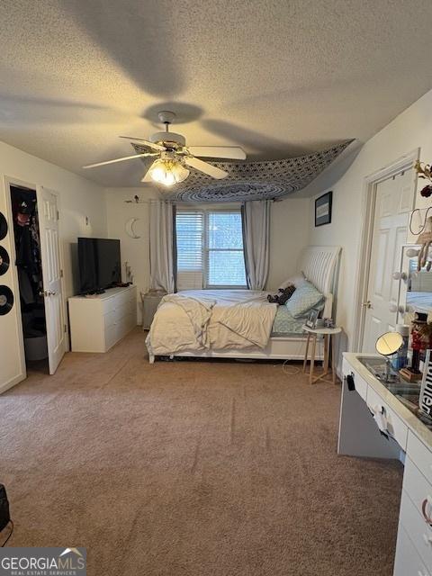 unfurnished bedroom with carpet, a textured ceiling, and ceiling fan