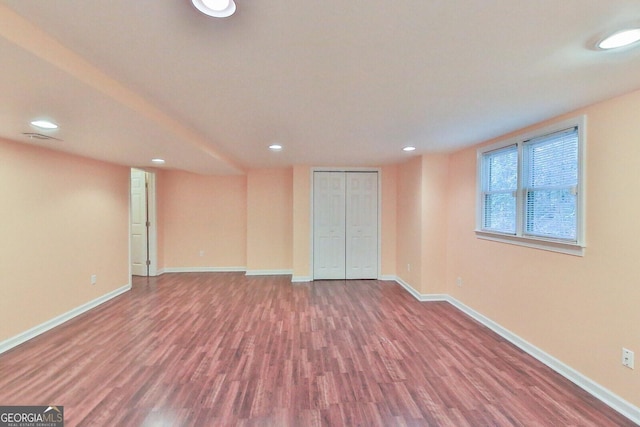 unfurnished room with wood-type flooring