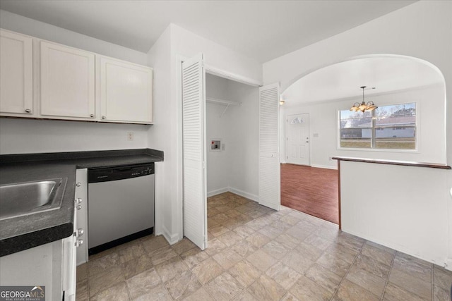 kitchen featuring dishwasher, sink, white cabinets, a chandelier, and hanging light fixtures