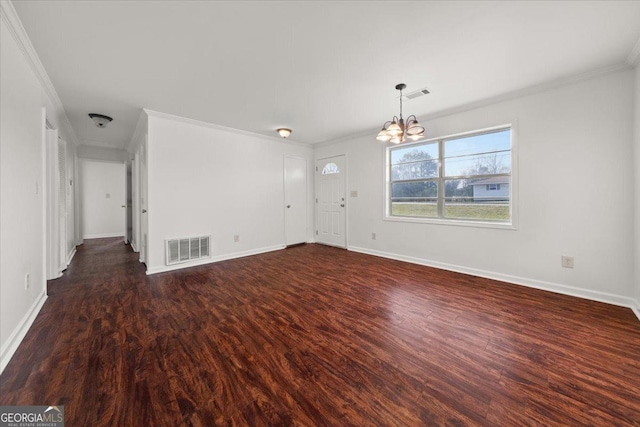 unfurnished room featuring ornamental molding, dark wood-type flooring, and a chandelier