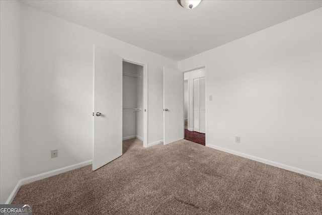 unfurnished bedroom with a closet and carpet