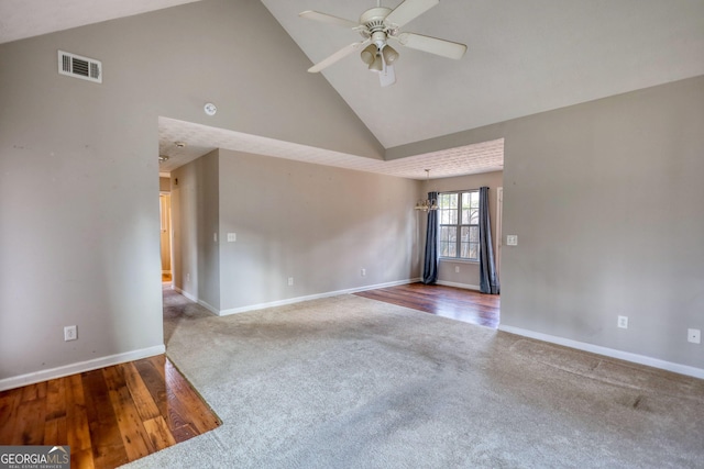 carpeted spare room featuring high vaulted ceiling and ceiling fan