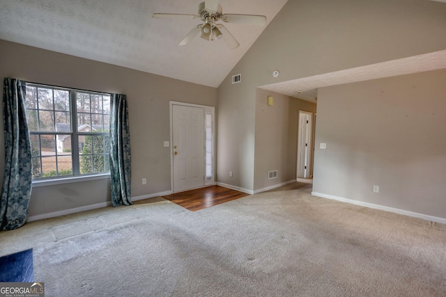 interior space with carpet floors, high vaulted ceiling, and ceiling fan