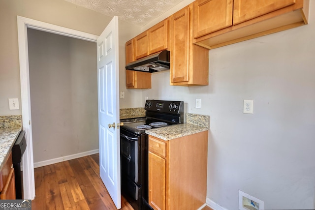 kitchen featuring dark hardwood / wood-style flooring, light stone counters, and black appliances