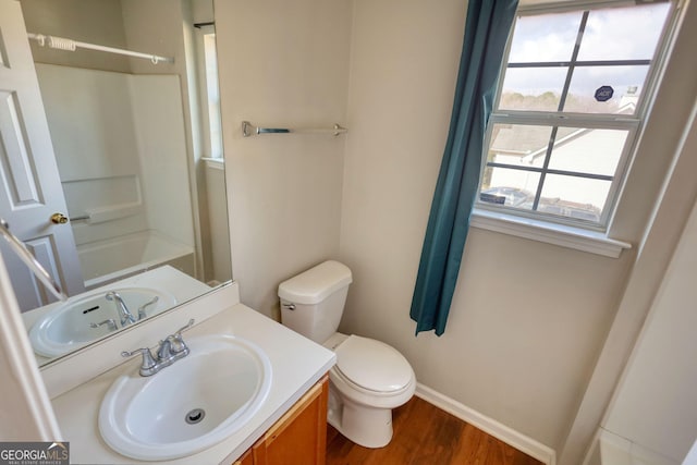 bathroom with hardwood / wood-style flooring, vanity, and toilet