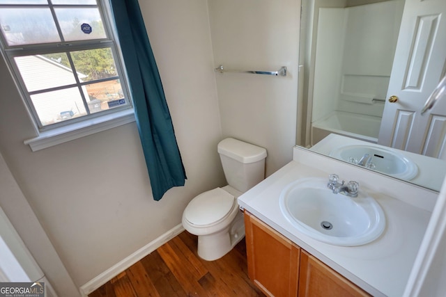 bathroom with vanity, hardwood / wood-style flooring, and toilet