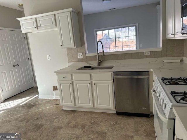 kitchen featuring sink, white range with gas stovetop, dishwasher, white cabinetry, and decorative backsplash