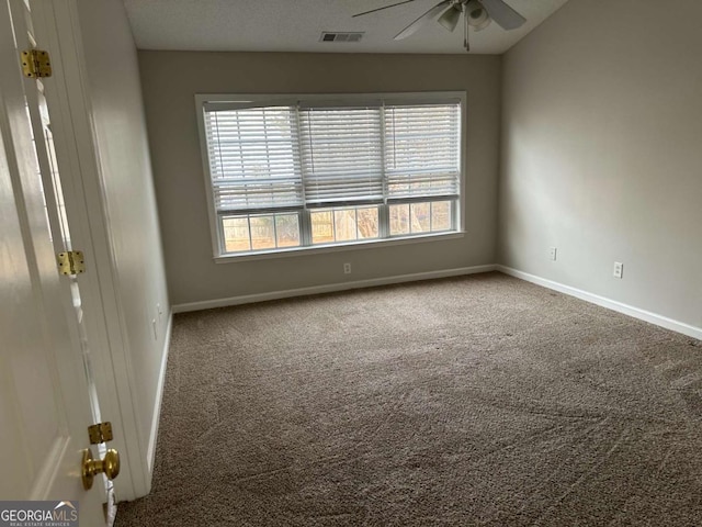 unfurnished room with ceiling fan and carpet flooring