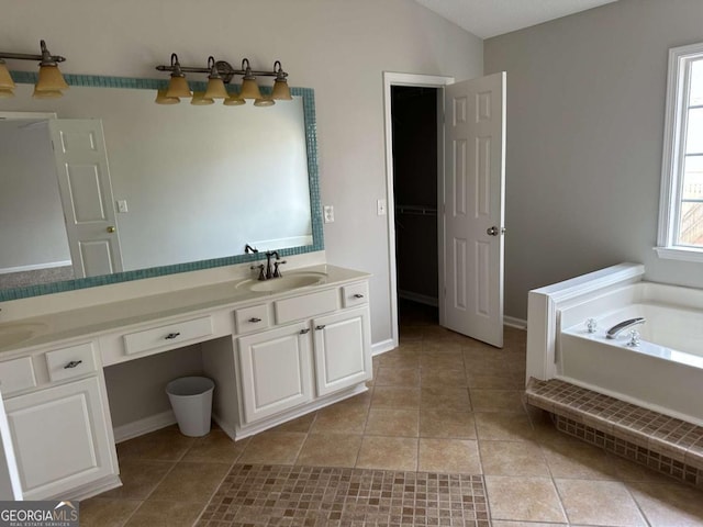 bathroom with vanity, vaulted ceiling, tile patterned floors, and a bathtub