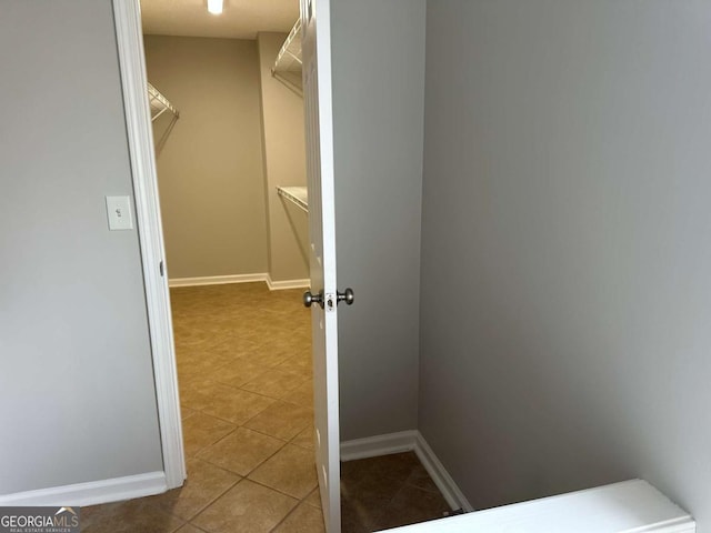 spacious closet featuring light tile patterned floors