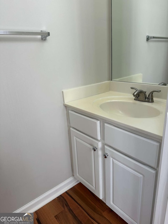 bathroom with vanity and wood-type flooring