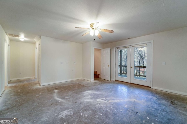 empty room with french doors, ceiling fan, concrete flooring, and a textured ceiling