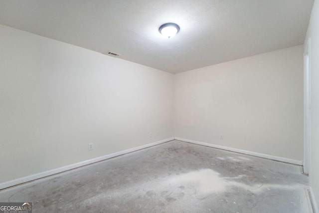 spare room with concrete flooring