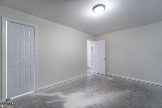 unfurnished room with concrete floors