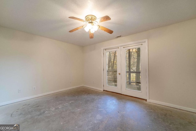 empty room with concrete floors, ceiling fan, and french doors