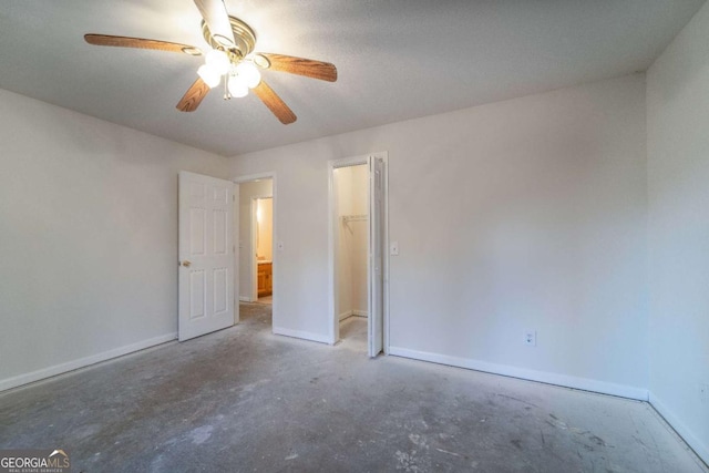 empty room featuring concrete flooring and ceiling fan